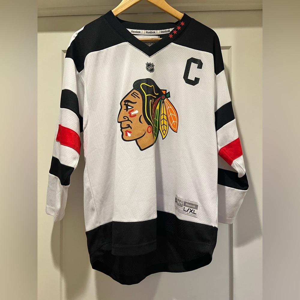Chicago Blackhawks Jersey; fits like an adult size, just a little shorter.
